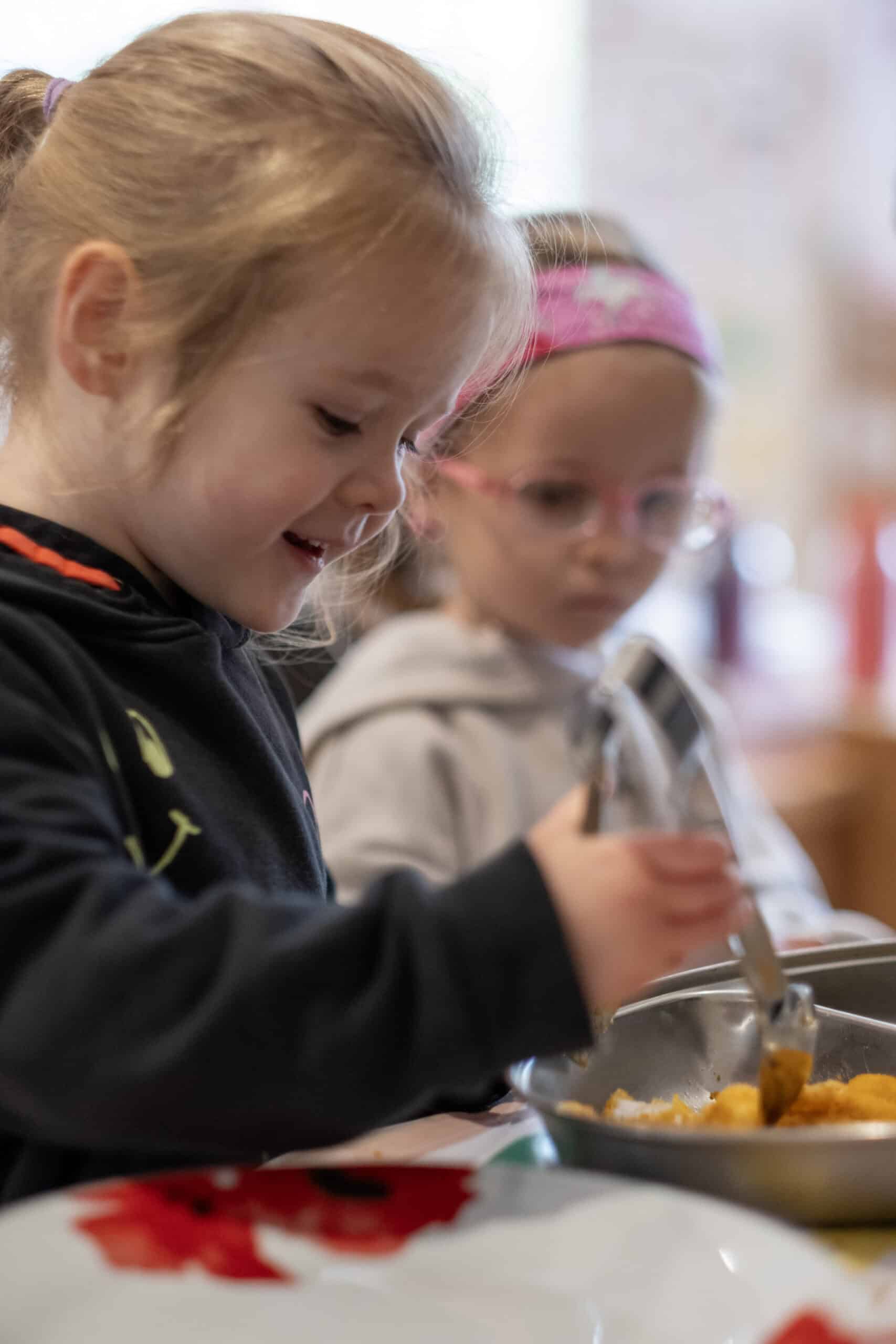 Children enjoying healthy meal at Thrive Childcare, engaging in nutritious eating and social interaction, promoting early development, balanced diet, and community.